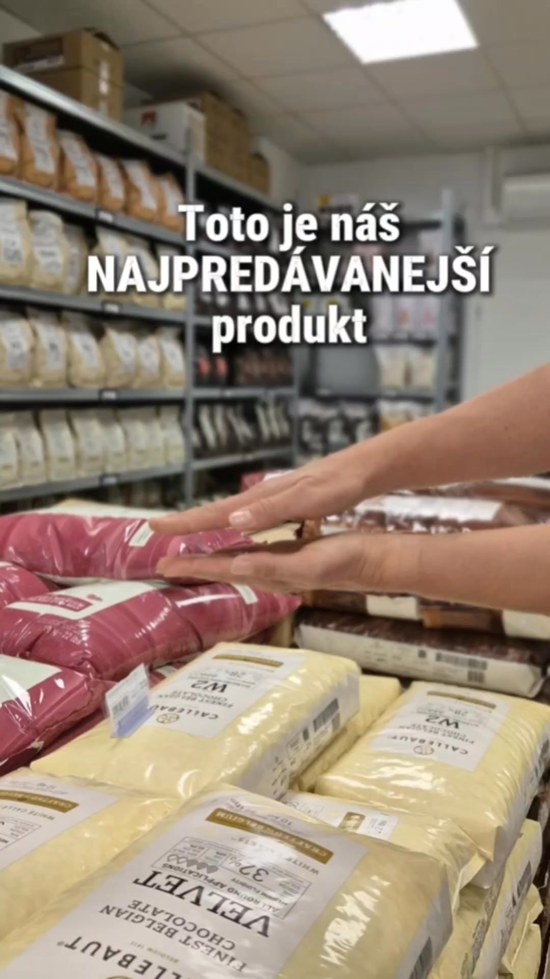 Hands pressing a block of cheese in a grocery store dairy aisle, with shelves of bags behind and text on screen reading 'Toto je náš NAJPREDAJANEJŠÍ produkt'.