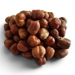 Pile of hazelnuts in brown shells on a white background